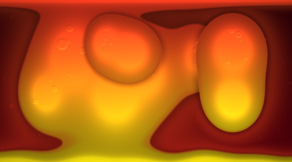 Orange and yellow wax blobs rising through red liquid