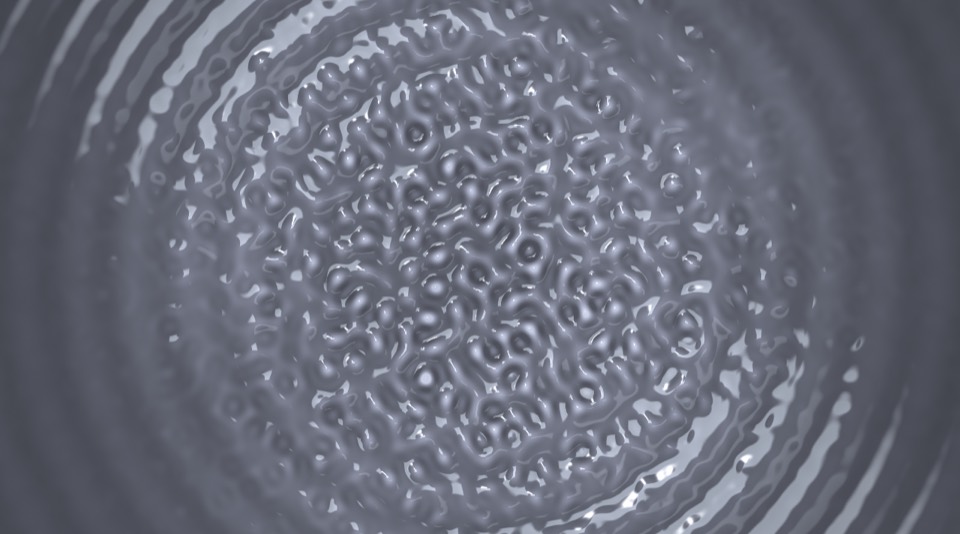Grey water rippled into a net of small cells with rings around them